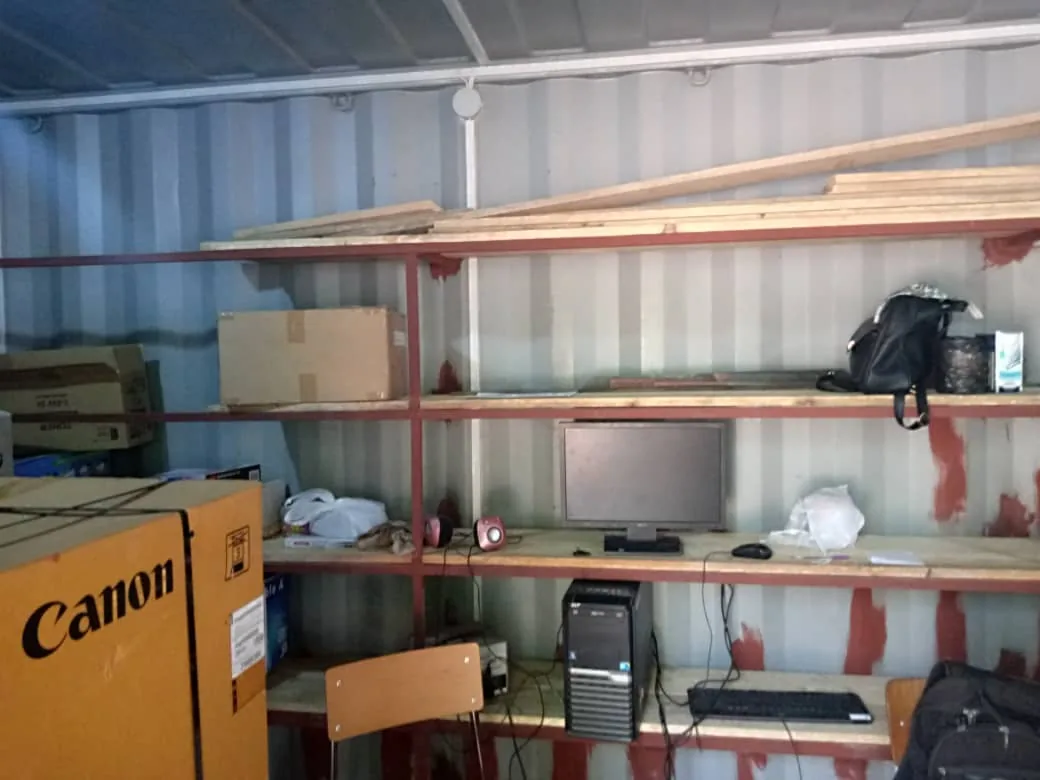 Estanterías con material escolar y equipos dentro de la Papelería Solidaria de Bissau