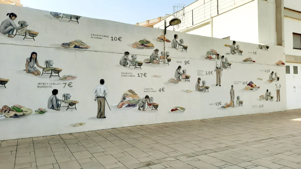 El mural d'ESCIF en què es basa Fashion Victims 2.0: nenes i nens cosint a màquina al costat de preus de roba barata